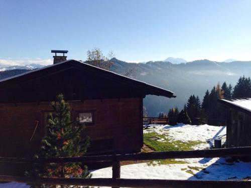 a cabin in the snow with a view of the mountains at Ferienhaus Kammerer in Haidberg