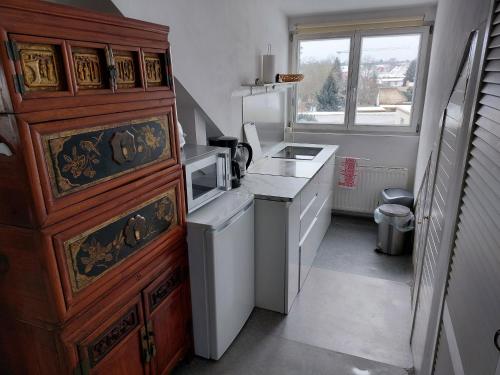a small kitchen with a sink and a stove at Ferienwohnung Heil - Königs Wusterhausen in Königs Wusterhausen