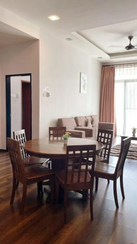 a living room with a table and chairs and a couch at Bayt Rizq Homestay 3R2B in Brinchang