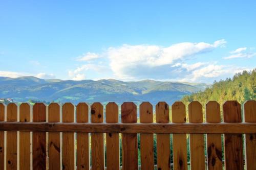 a wooden fence with a view of mountains behind it at Annenhütte in Reichenfels