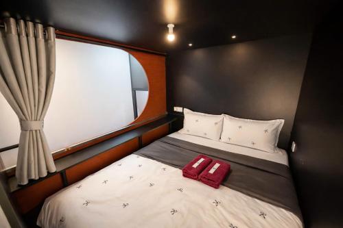 a small bed in a room with a window at Start House 5 mins walk Airport in Ho Chi Minh City