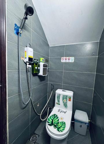 a bathroom with a toilet with a shower in it at Start House 5 mins walk Airport in Ho Chi Minh City