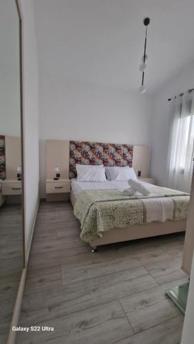 a bedroom with a bed and a mirror at Villa Sofia in Kalives Poligirou