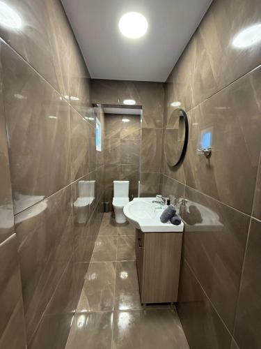 a bathroom with a sink and a toilet at Limassol center Soul in Limassol
