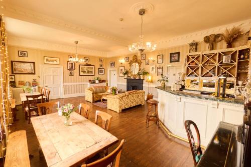a living room with a table and a dining room at Preston House in Abbeyleix