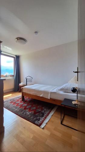 a bedroom with a large bed and a large window at Gästehaus FaRitz in Knittelfeld