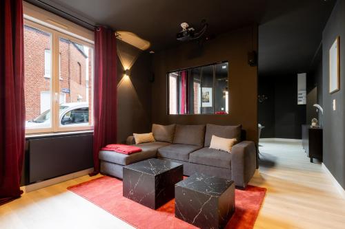 a living room with a couch and a window at Ciné Suite - Arras 5 guests in Arras