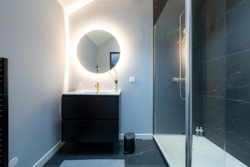 a bathroom with a sink and a mirror at Ciné Suite - Arras 5 guests in Arras