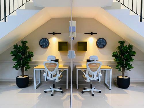 an attic office with two desks and clocks at Hanah Home Pagoh in Pagoh