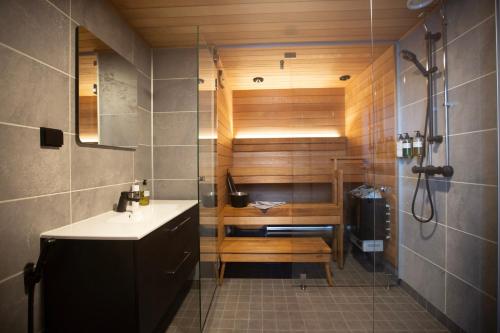 a bathroom with a shower and a sink at Riekko Lodge in Äkäslompolo