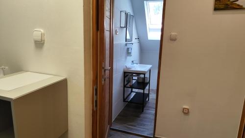 a small bathroom with a sink and a mirror at Arcadia Guesthouse in Ábrahámhegy