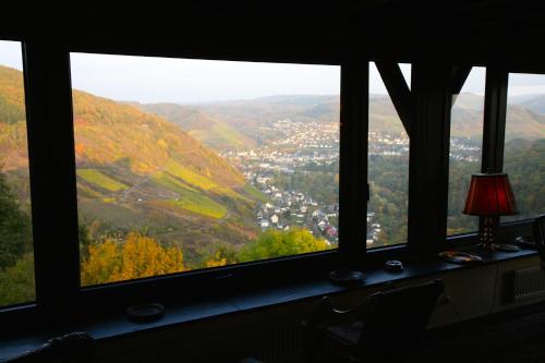 a window with a view of a city from a mountain at Hotel Burg Arras in Alf