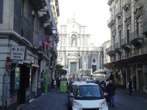 a car parked on a street in front of a building at Hotel Gorizia in Catania
