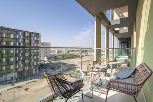 a balcony with chairs and a view of the beach at Frank Porter - The Pulse Residences in Dubai
