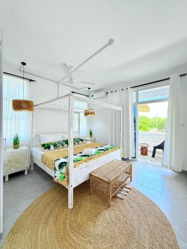a bedroom with a canopy bed and a rug at Malindi Modern 2BR Near the Beach With a Private Pool in Malindi