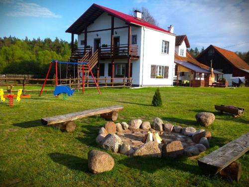 a park with a playground and a house at Apartment by Interhome in Łukta