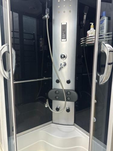 a shower with a hose in a small bathroom at Apartments Velora in Kryvyi Rih