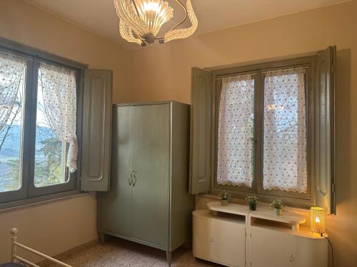 a bathroom with a sink and two windows at il nuvoloso in Città della Pieve