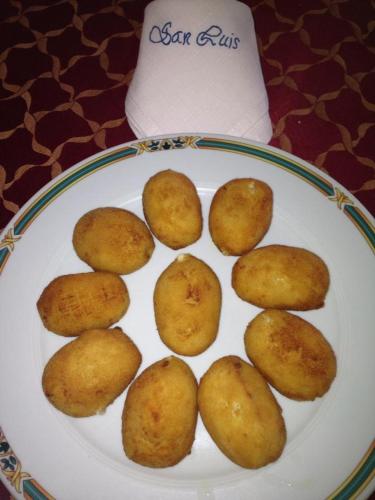 a plate of fried food on a table at Hostal San Luis in Almodóvar del Río