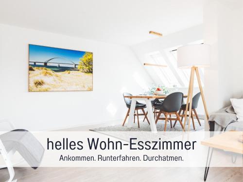 a dining room with a table and a view of a bridge at Casa Ueberall - Ruhige DG-Ferienwohnung für 2 Erwachsene in Burg - Balkon mit Abendsonne, hochwertige Ausstattung, überdachter E-Bike-Stellplatz, Nähe zur Altstadt & Restaurants in Fehmarn
