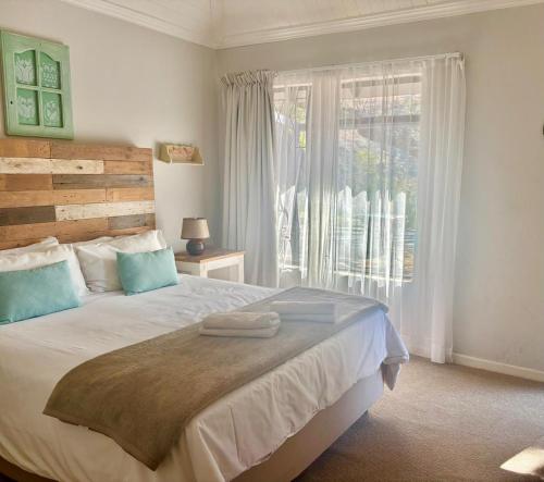 a bedroom with a large bed and a window at Ledges Retreat in Bergville
