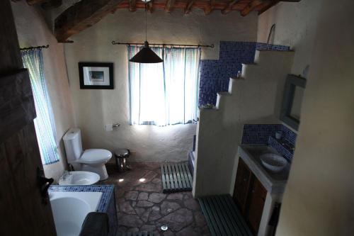 a bathroom with a staircase and a toilet and a sink at La Balconata in Bagni di Lucca