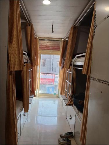 a room with a hallway with bunk beds and a doorway at Jaiswal Home Stay in Rishīkesh