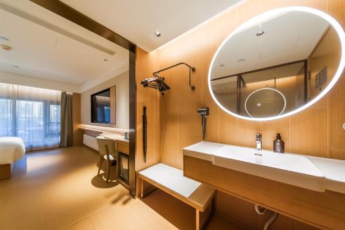 a bathroom with a sink and a mirror at JI Hotel Beijing Station in Beijing
