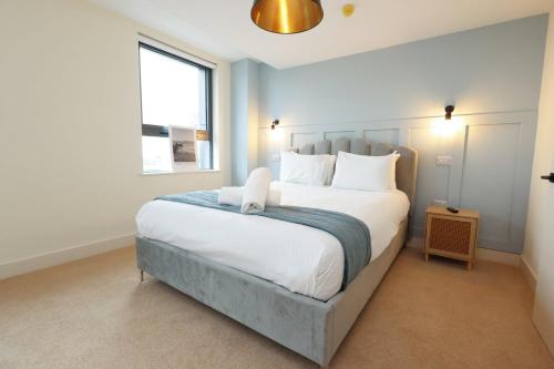 a bedroom with a large bed with white pillows at The Swansea Central Hall 1 Bed Room Apartment in Swansea