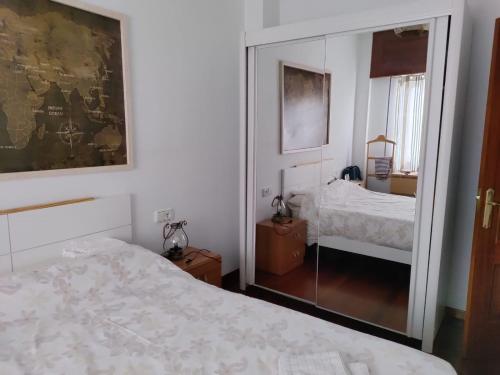 a bedroom with a bed and a large mirror at María II in Ferrol