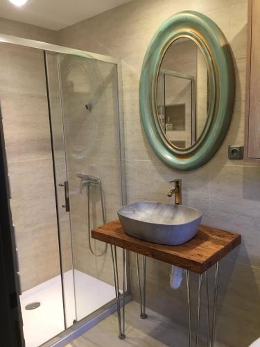 a bathroom with a sink and a glass shower at Apartmány Za Zvončekom in Vydrná