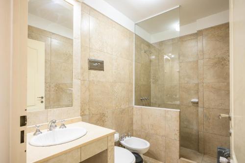 a bathroom with a sink and a toilet and a shower at Aguas Claras Hosteria in Santa Rosa de Calamuchita