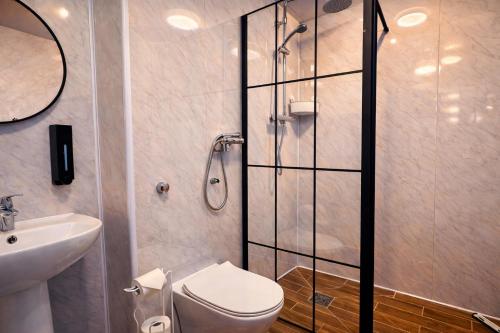 a bathroom with a shower and a toilet and a sink at Royal Chambers Liverpool in Liverpool