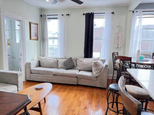 a living room with a couch and a table at Group Getaway of West New York in West New York