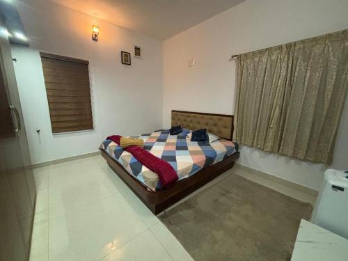 a bedroom with a bed and a window in a room at Seven Peak Hostel in Chikmagalūr