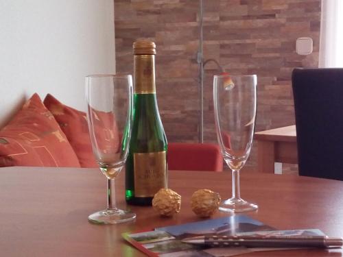a bottle of wine and two glasses on a table at Apartment mit Balkon by Interhome in Gorje