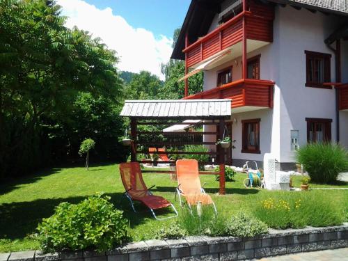 a group of chairs in the yard of a house at Apartment mit Balkon by Interhome in Gorje