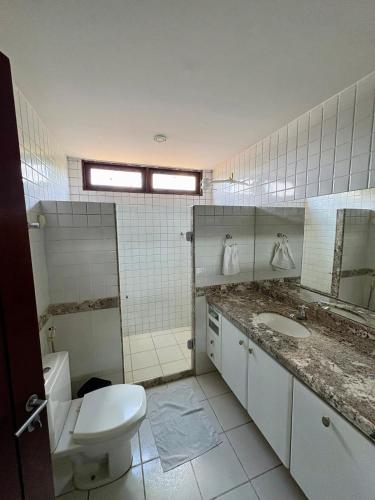 a bathroom with a toilet and a sink at Lira Hostel in Caruaru