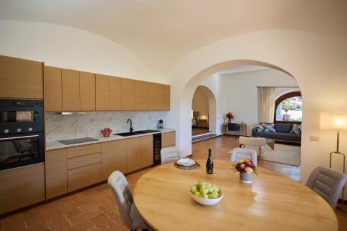 a kitchen and a table with a bowl of fruit on it at Villa Belora in Gera Lario