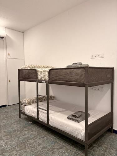 a bunk bed room with two bunk beds in it at LITTLE Hostel in Puerto de Sagunto