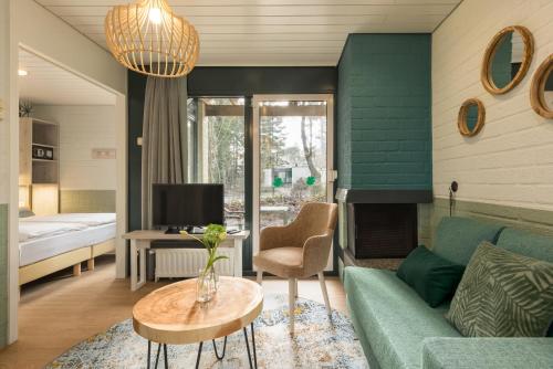 a living room with a couch and a bed at Center Parcs Apartments Erperheide in Peer