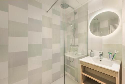 a white bathroom with a sink and a shower at Center Parcs Apartments Erperheide in Peer