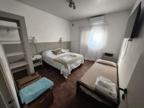 a small bedroom with a bed and a window at San Lorenzo II in Chacabuco