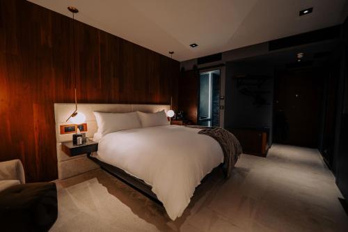 a bedroom with a large white bed and a window at Cave Hotel & Golf Resort in Faversham