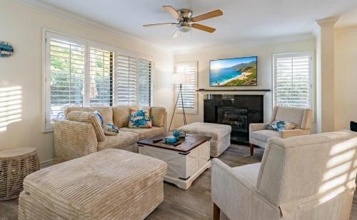 a living room with a couch and a fireplace at Luxe 2-Story Oasis with Private Pool & Backyard in Laguna Niguel