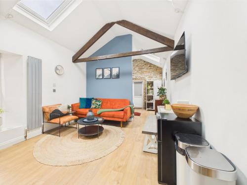 a living room with a couch and a table at Stylish Central Famouth Studio with Parking | WiFi | in Falmouth