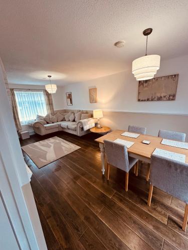 a living room with a table and a couch at Comfy 3 Bed House in Northampton