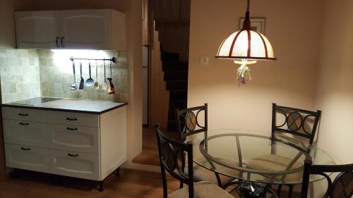 a kitchen with a glass table and a dining room at Vila Gabriela in Buşteni