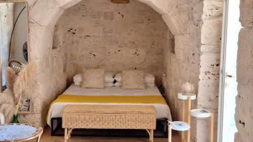 a bedroom with a bed in a stone wall at Residenza Anima Mediterranea in Francavilla Fontana