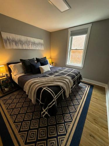 a bedroom with a large bed and a window at Cozy unit King bed & laundry in Wilmington